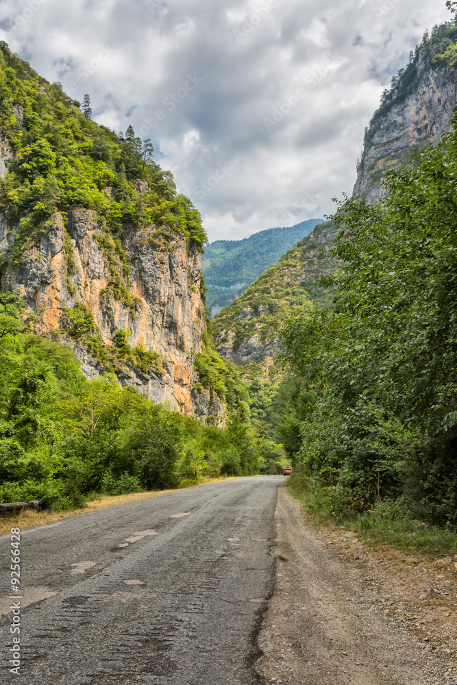 Asphalt road by mountain gorge