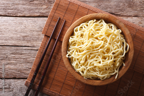 Asian ramen noodles in wooden bowl. horizontal top view
