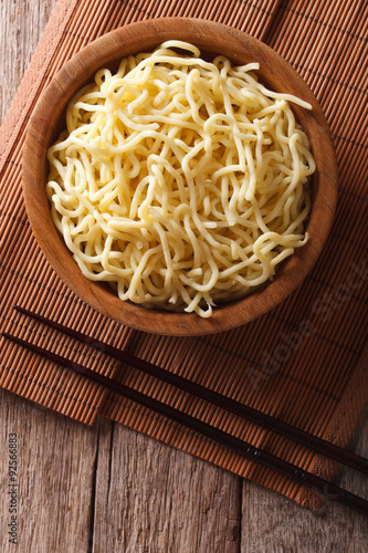 Asian ramen noodles in wooden bowl. vertical top view
