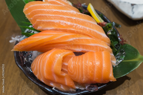 Salmon Sashimi over ice on black bowl