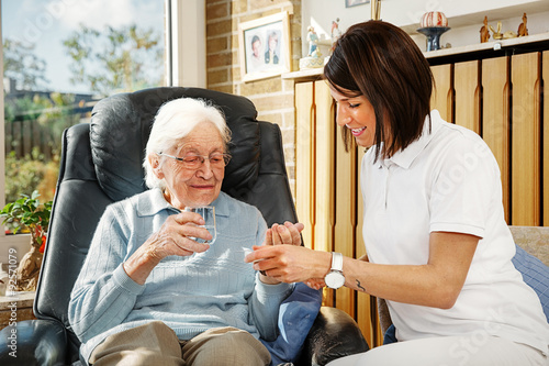Nurse caring for elderly person photo