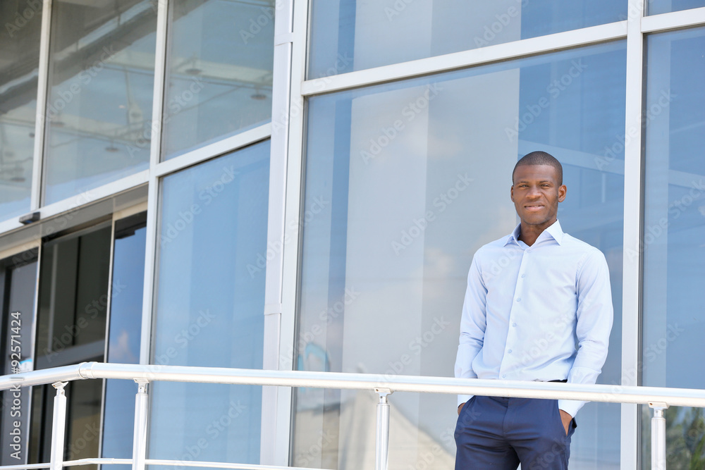 Handsome African American businessman near business centre Handsome African American businessman near business centre