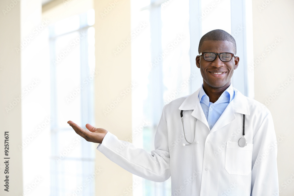 Handsome African American doctor with stethoscope in hospital Handsome African American doctor with stethoscope in hospital