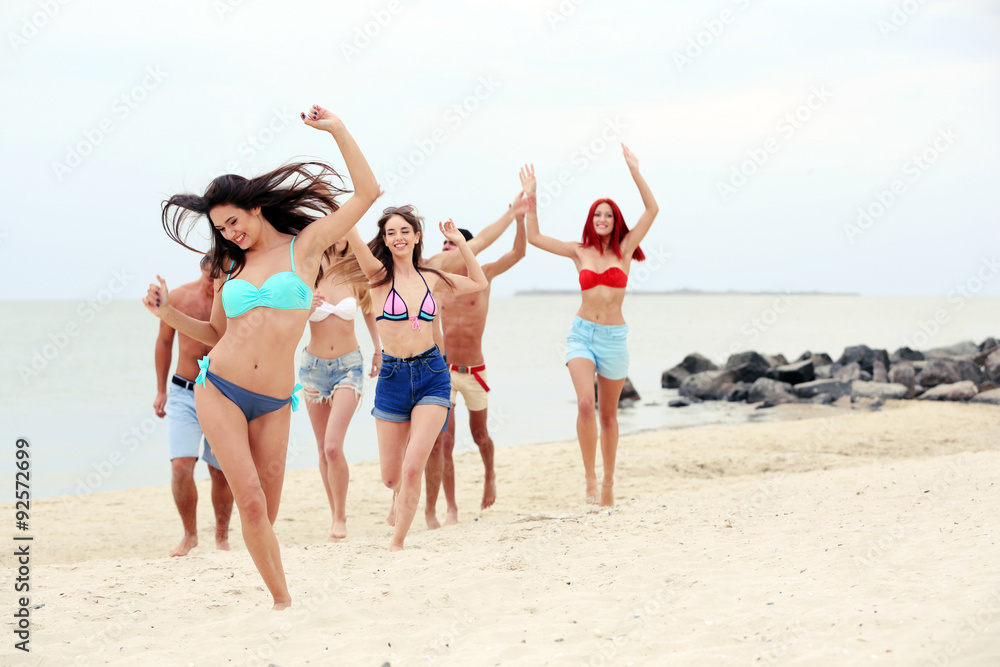 Beautiful young people having fun on beach