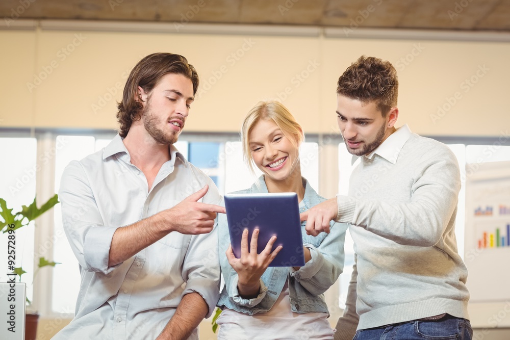 Happy businesswoman holding laptop with colleagues Happy businesswoman holding laptop with colleagues