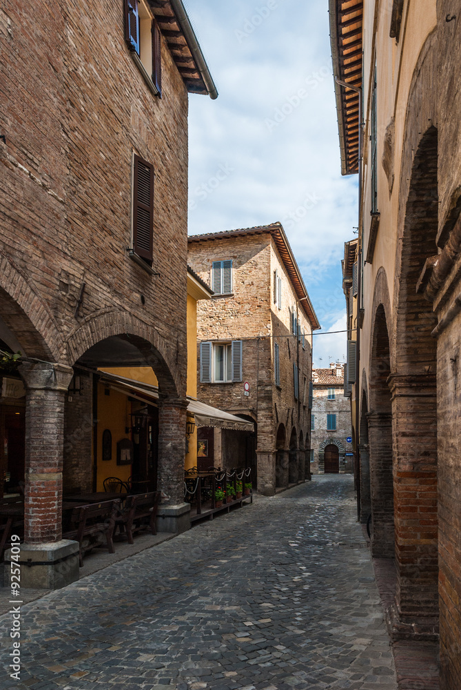Narrow street with cobbles in the small medieval town of Urbania (Marche region, Italy)