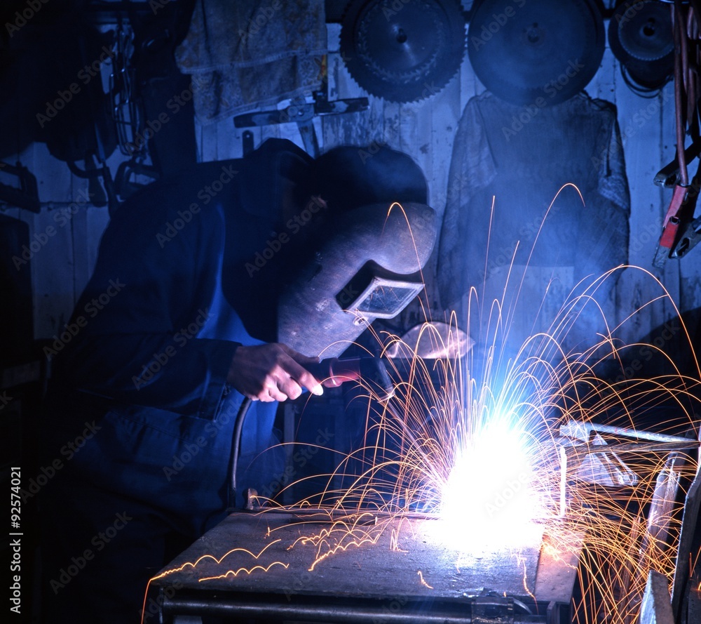 Man welding in a workshop. Man welding in a workshop.