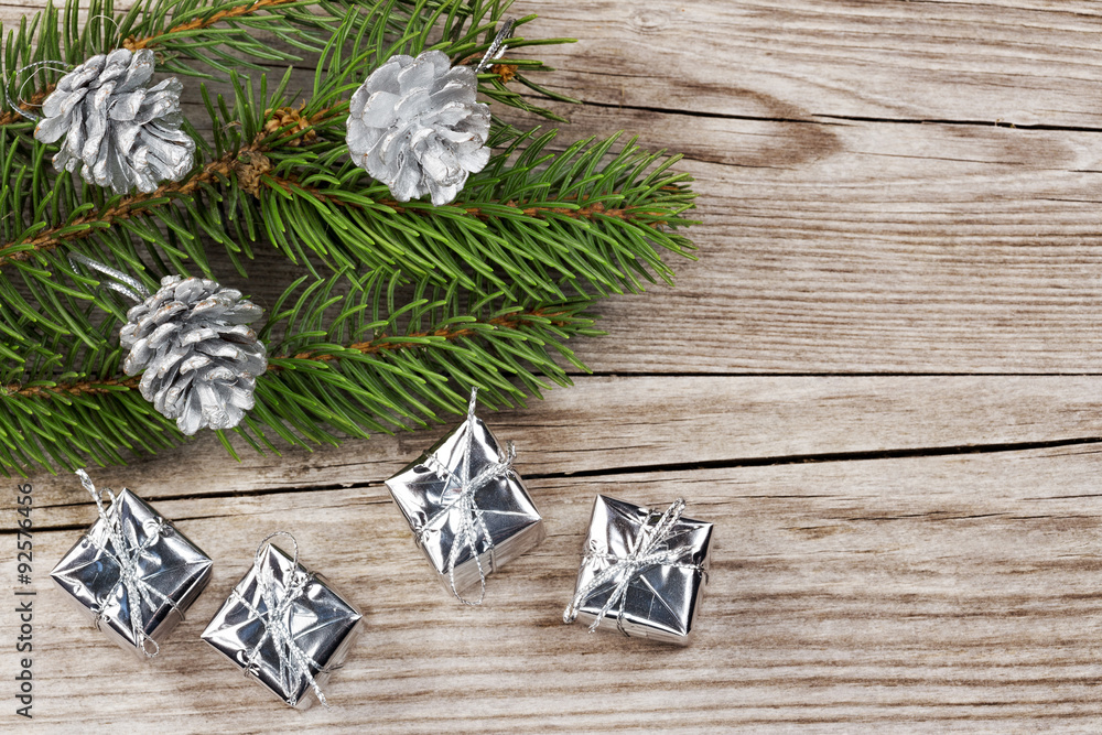 fir branch, silver fir cones and gift boxes on wood fir branch, silver fir cones and gift boxes on wood