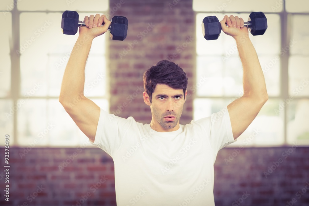 Portrait of muscular man lifting dumbbells Portrait of muscular man lifting dumbbells