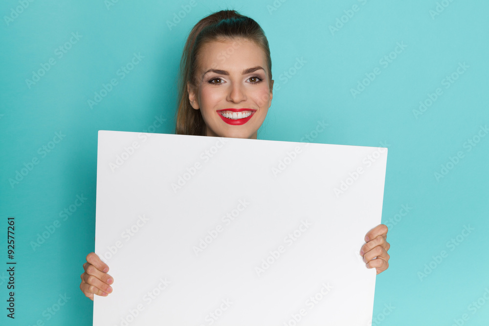 Girl With Beautiful Smile Holding White Poster Girl With Beautiful Smile Holding White Poster