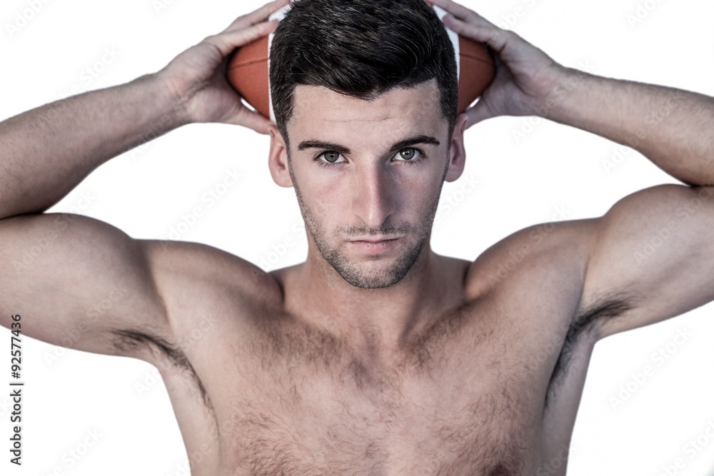 Fototapeta premium Portrait of a man holding ball over his head