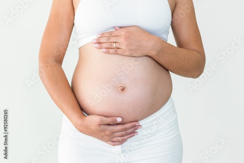 Pregnant woman touching tummy