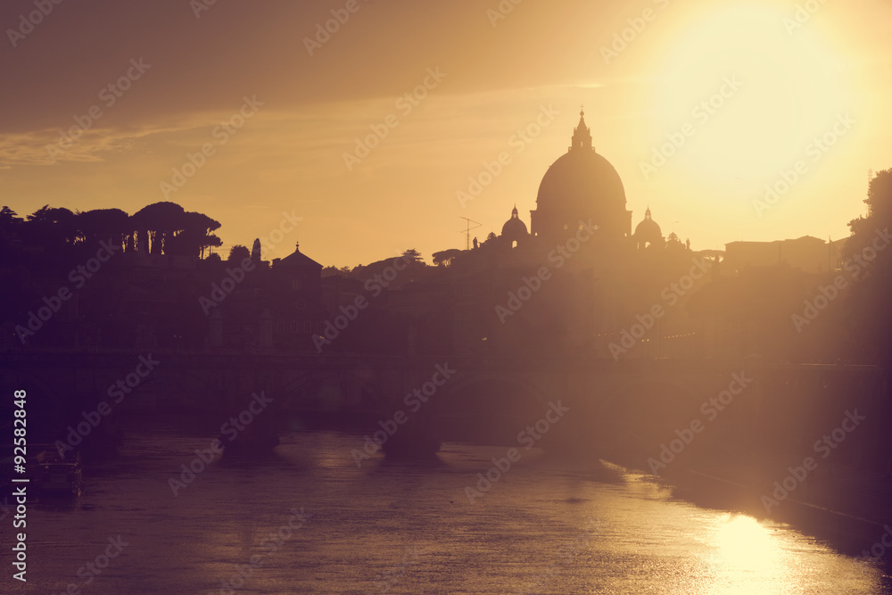 St. Peter's Basilica, Vatican City.  Tiber river in Rome, Italy at sunset