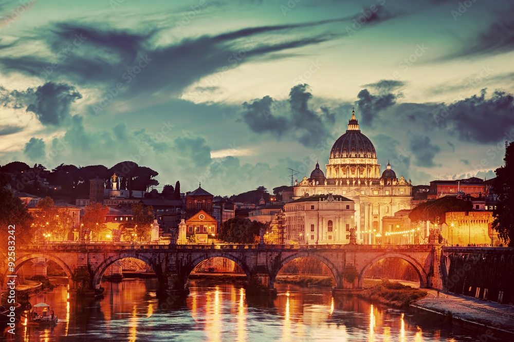 St. Peter's Basilica, Vatican City.  Tiber river in Rome, Italy at late sunset, evening.
