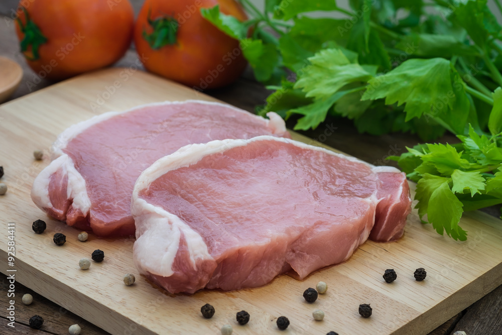 Raw pork meat sliced on wooden cutting board Raw pork meat sliced on wooden cutting board