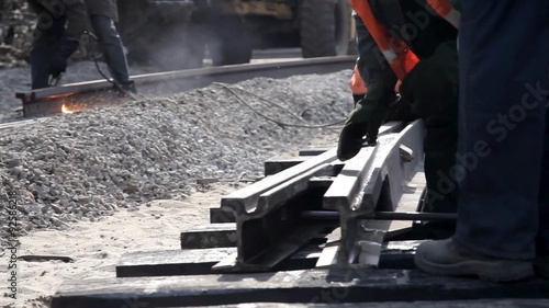 Railway workers bolting track rail 