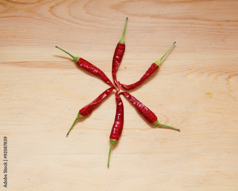 Six pieces of Red Hot Chili Peppers over wooden background Six pieces of Red Hot Chili Peppers over wooden background