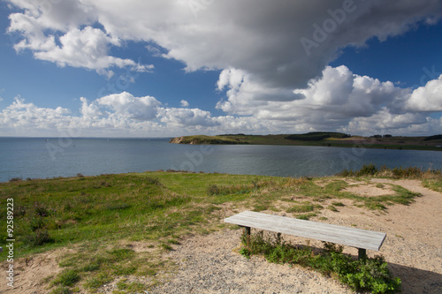 Wooden bench on the coast of the Batlic Sea photo