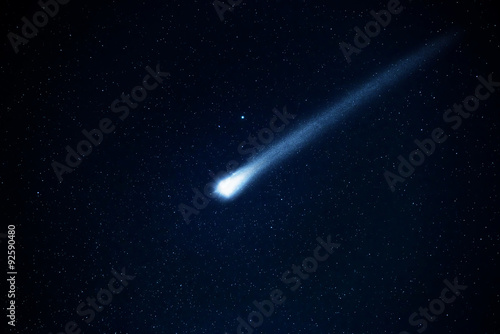 Comet in the starry sky. Elements of this image furnished by NASA. photo