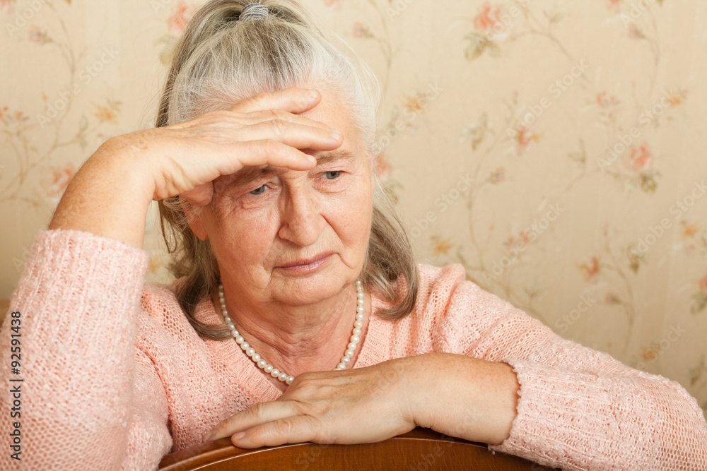 Elderly woman grieves at home. Elderly woman grieves at home.