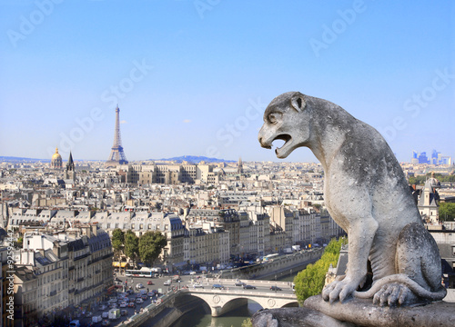 Fotografia Gargoyle overlooking Paris up on Notre Dame de Paris, France