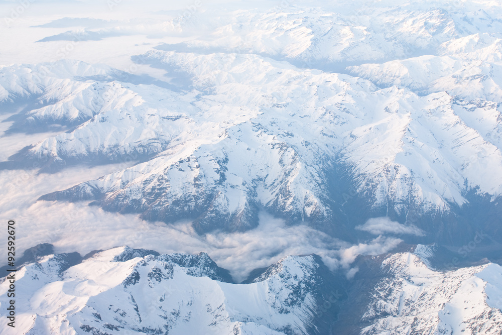 Above the clouds aerial view of snowcapped andes mountains