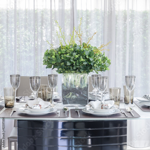 table set with glass vase of flower