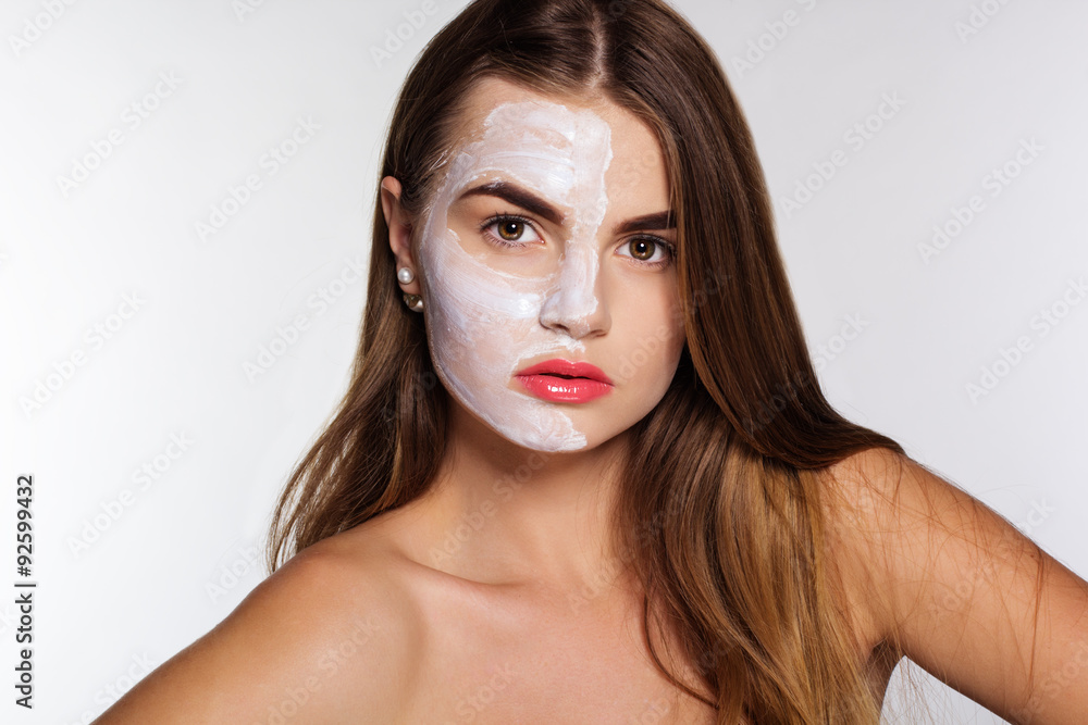 Fototapeta premium Beauty girl with clay face pack, spa concept