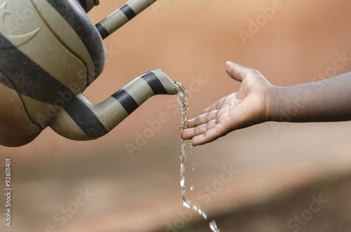 Black Boy Washing Hands, Clean Water (Developing Countries). Washing hands is vitally important to mantain a good health. photo