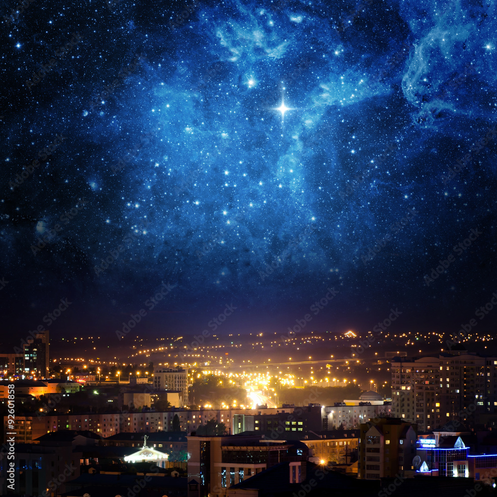 City landscape at nigh with sky filled with stars. Elements of this image furnished by NASA.