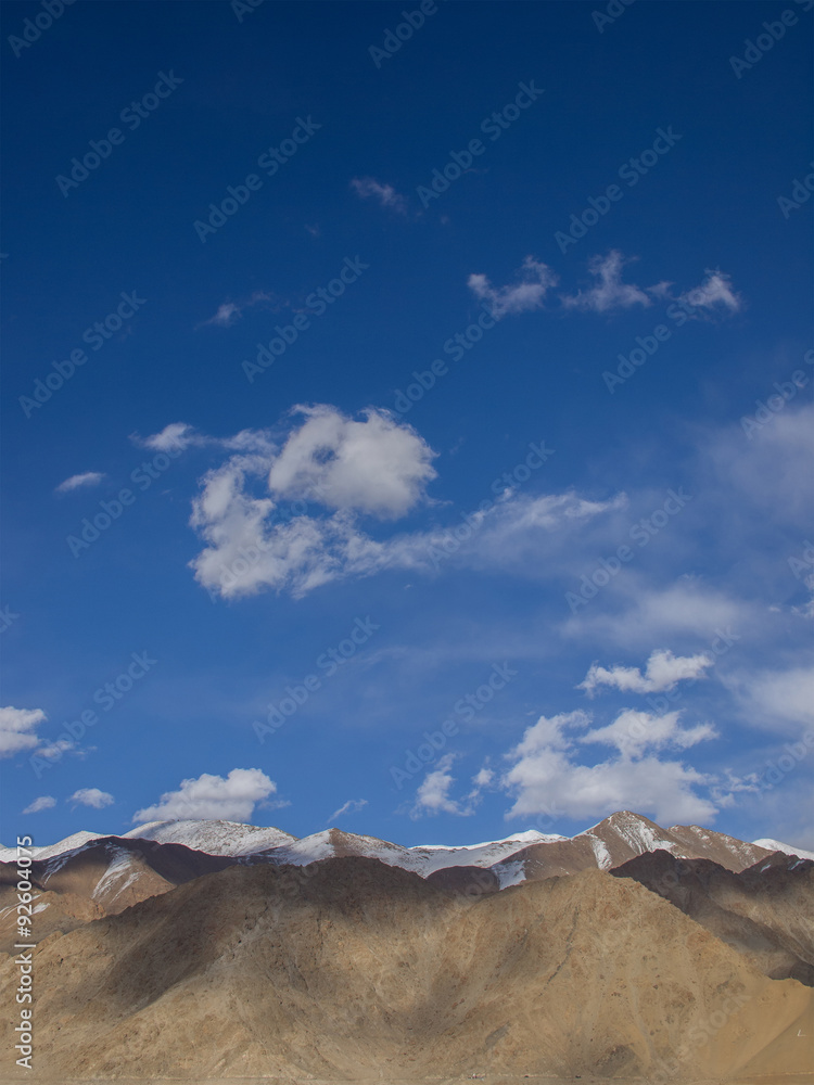 Brown mountains and 80 percent of area of blue sky and some cl Brown mountains and 80 percent of area of blue sky and some cl