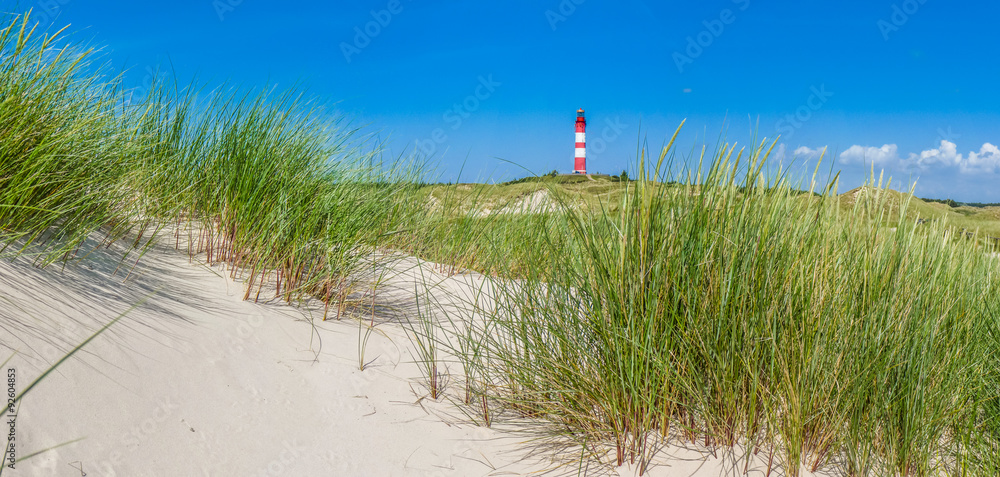 Dune landscape with lighthouse at North Sea