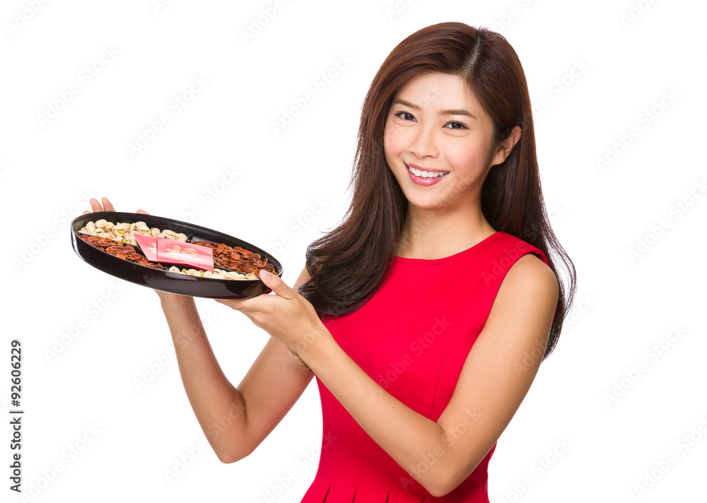 Chinese young woman hold with snack tray for lunar new year