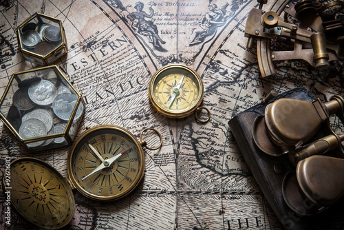 Old compass, astrolabe on vintage map. Retro style. photo