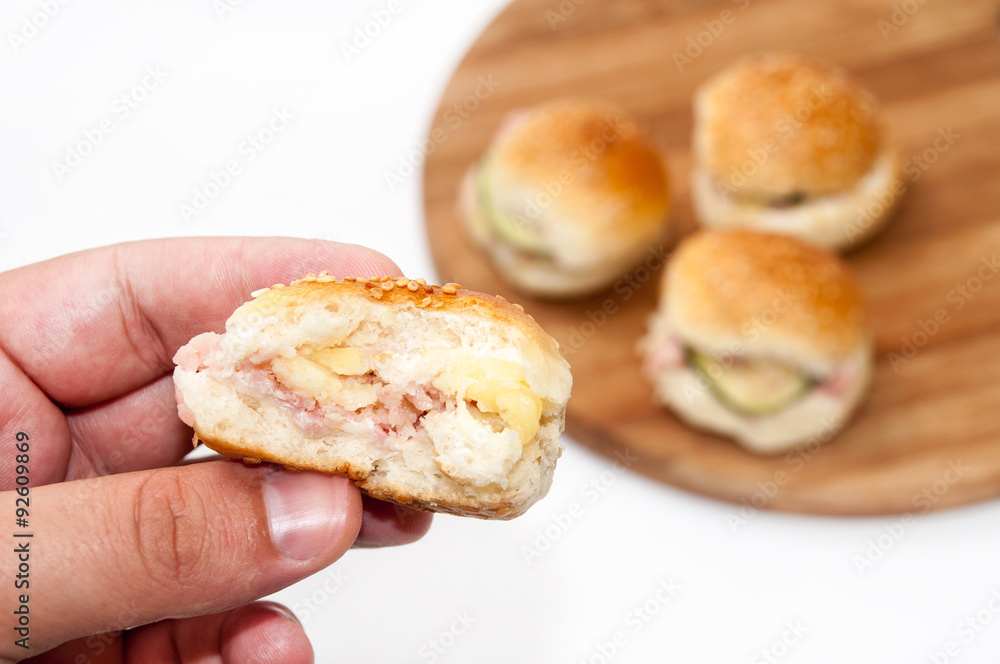 Hand holding hamburger sandwiches Hand holding hamburger sandwiches