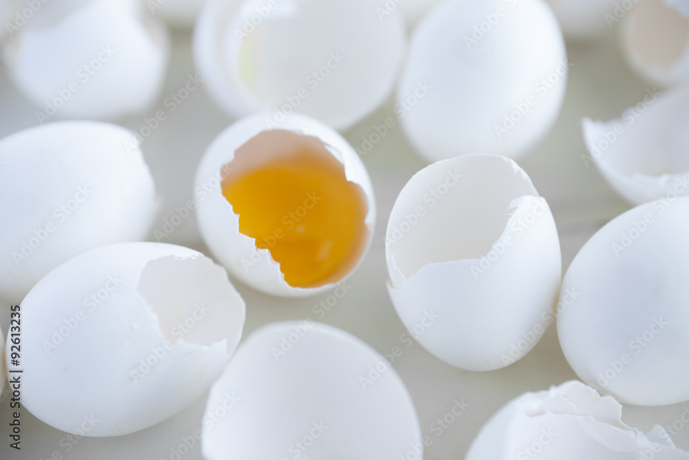 Broken eggs. Closeup view of broken eggs with yolk inside one of them. Broken eggs. Closeup view of broken eggs with yolk inside one of them.