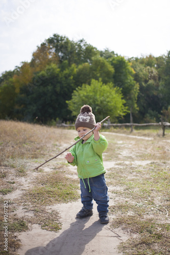 A boy with a stick.