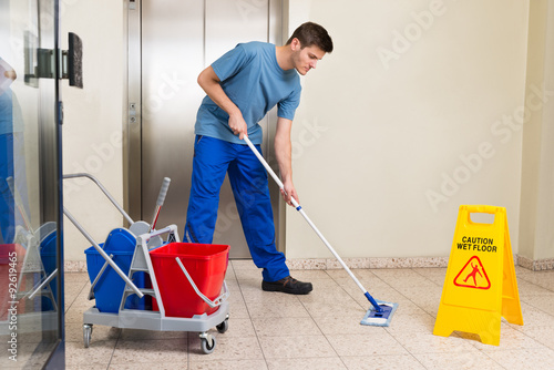 Male Janitor Mopping Floor