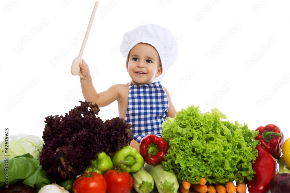 Smiling little chef with vegetables Smiling little chef with vegetables