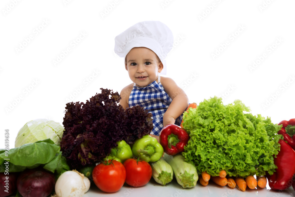 Smiling baby cook with vegetables Smiling baby cook with vegetables