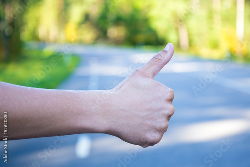 close up of male hand hitchhiking