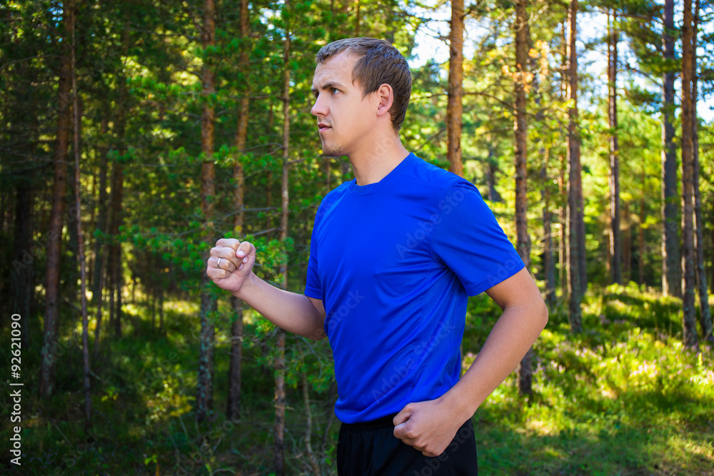 jogging - handsome man running in forest jogging - handsome man running in forest