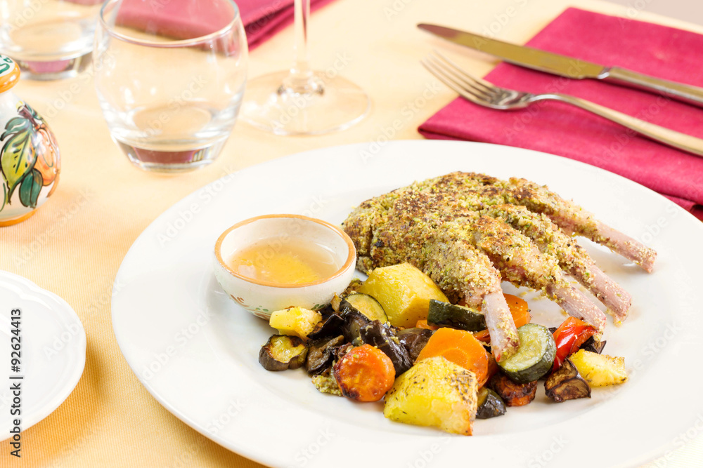 lamb cutlet cooked with pistachio crust and grilled vegetables a lamb cutlet cooked with pistachio crust and grilled vegetables a