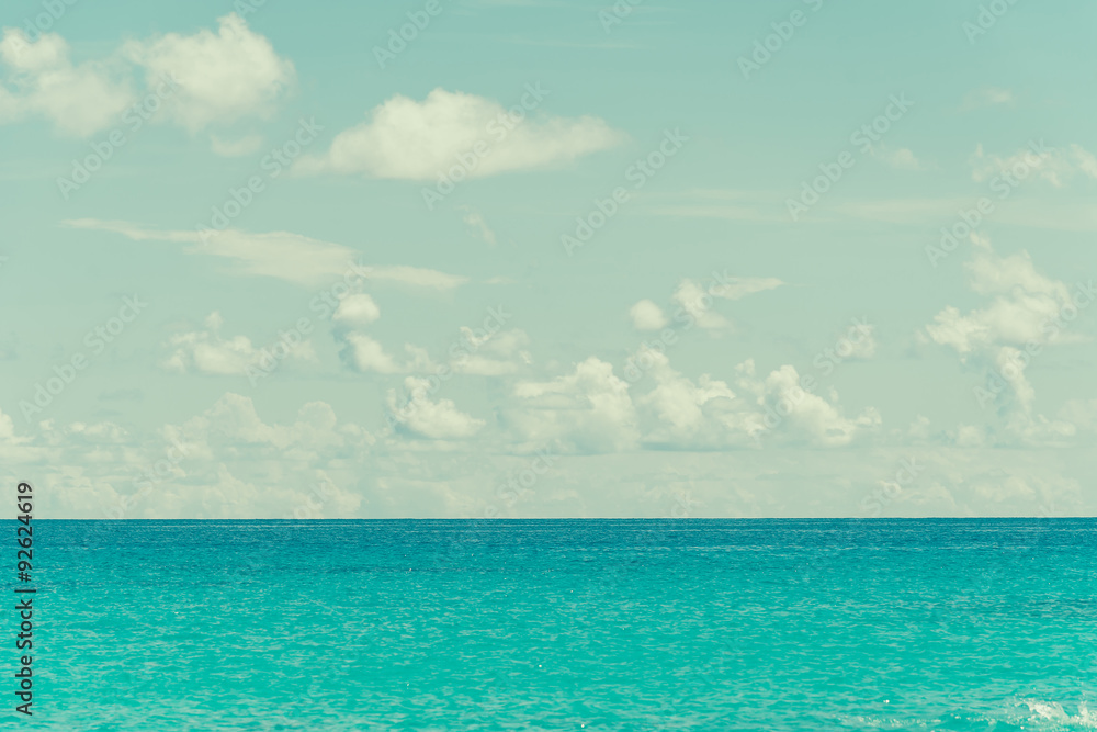 blue sky and water of ocean - vintage film filter