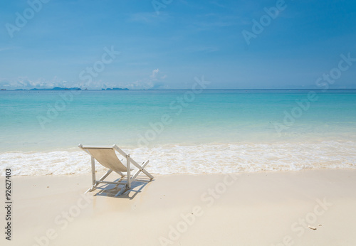 beach chair on beach with blue sky
