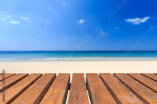 Empty top of wooden table and view of tropical beach