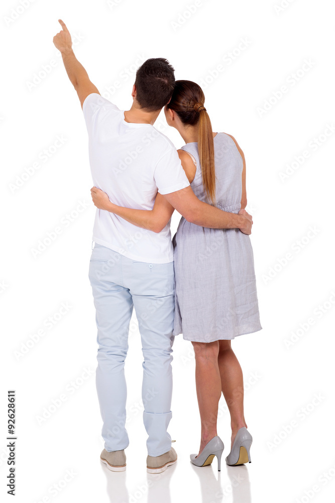 rear view of married couple pointing rear view of married couple pointing