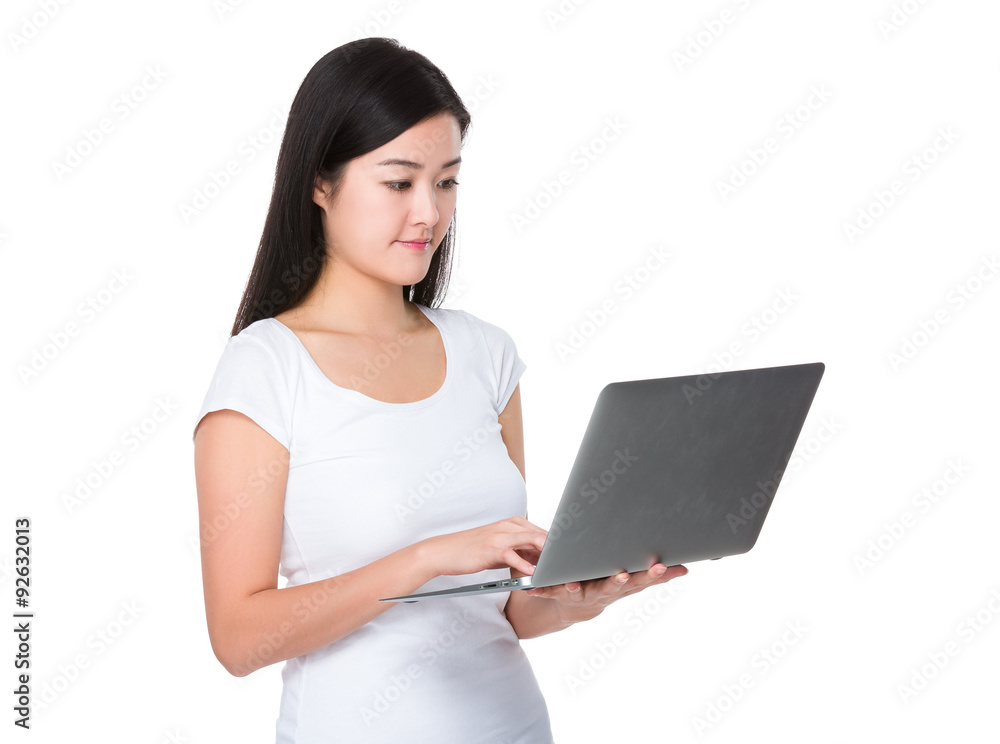 Asian young woman read on the laptop computer Asian young woman read on the laptop computer