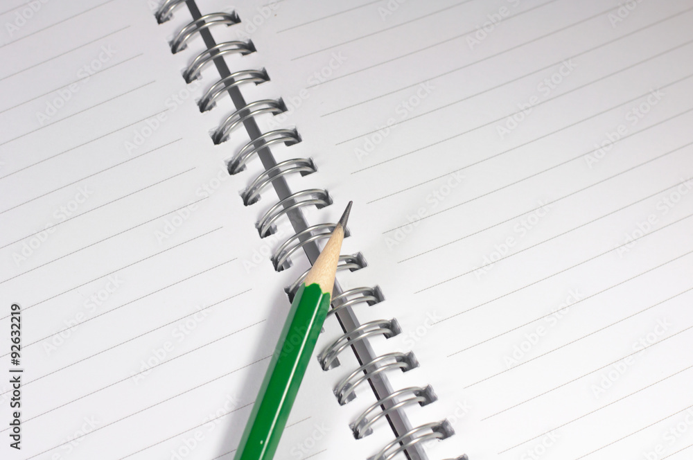 the empty notebook with green pencil, ready to note or work the empty notebook with green pencil, ready to note or work