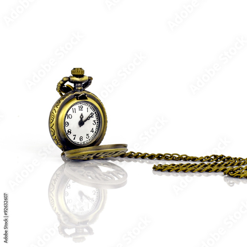 Vintage pocket watch on white background with reflection.